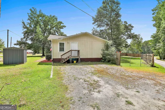 a view of backyard with a garden and entertaining space