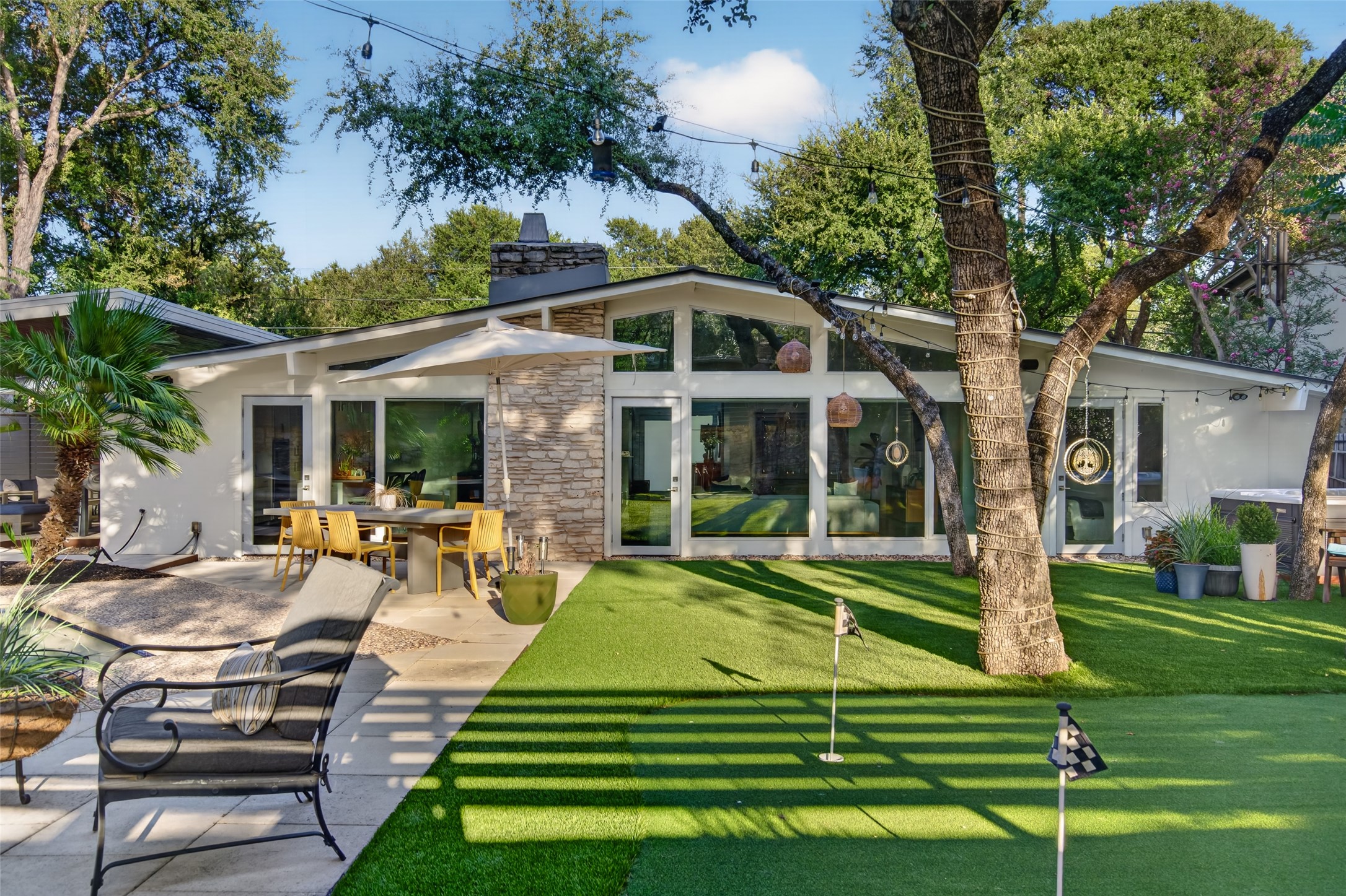 412 Ridgewood Road West Lake Hills, TX 78746 - Photo 26 of 40 Private yard featuring mature trees, a putting green and ample space for outdoor dining.