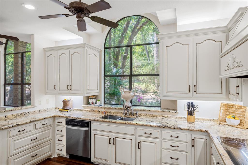 148 Pinewood Cove Holly Lake Ranch, TX 75765 - Photo 13 of 40 a kitchen with granite countertop a window a sink and cabinets