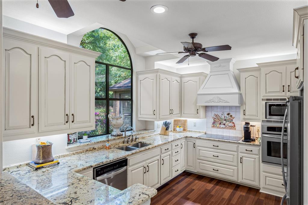 148 Pinewood Cove Holly Lake Ranch, TX 75765 - Photo 14 of 40 a kitchen with stainless steel appliances granite countertop a stove a sink and a refrigerator