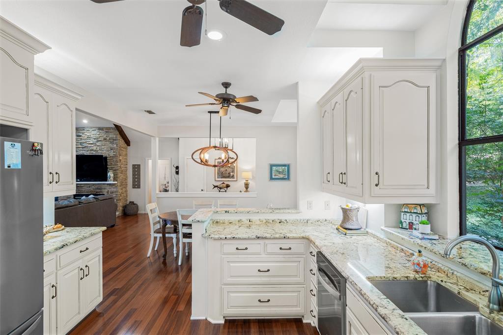 148 Pinewood Cove Holly Lake Ranch, TX 75765 - Photo 15 of 40 a kitchen with a stove a sink and a refrigerator