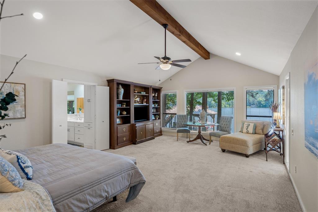 148 Pinewood Cove Holly Lake Ranch, TX 75765 - Photo 17 of 40 a bedroom with a bed couch and a large window