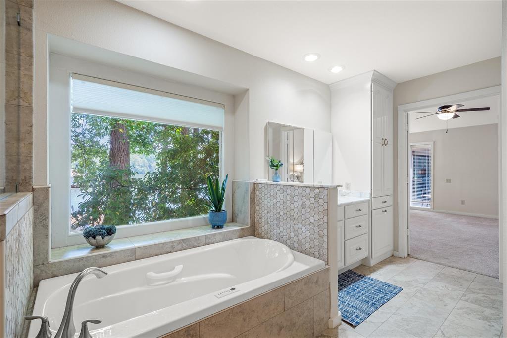 148 Pinewood Cove Holly Lake Ranch, TX 75765 - Photo 20 of 40 a bathroom with a bathtub and a shower