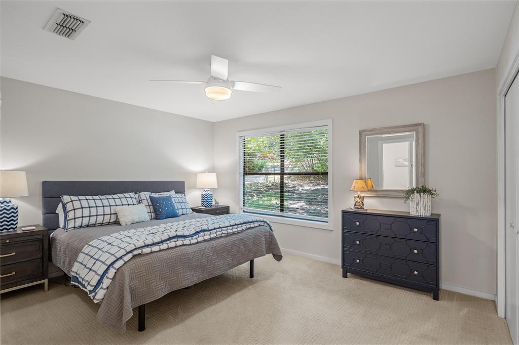 148 Pinewood Cove Holly Lake Ranch, TX 75765 - Photo 21 of 40 a spacious bedroom with a bed and a dresser