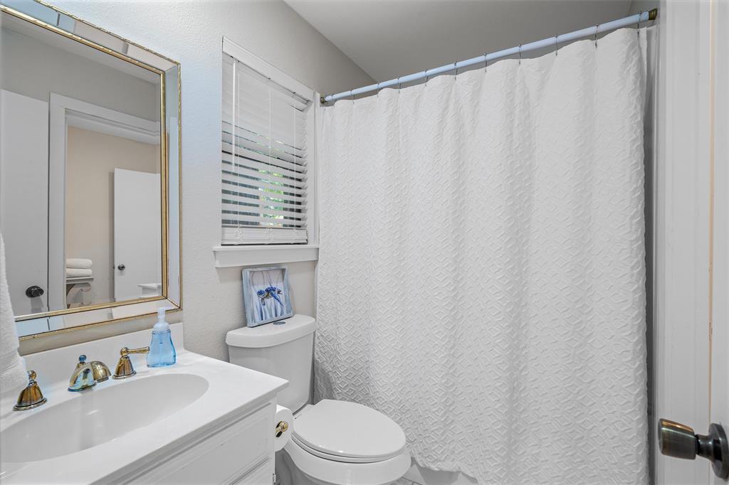 148 Pinewood Cove Holly Lake Ranch, TX 75765 - Photo 22 of 40 a bathroom with a sink a toilet and a mirror