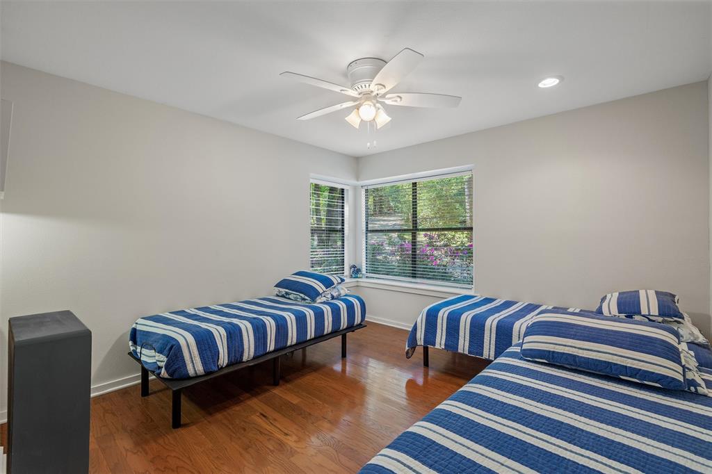 148 Pinewood Cove Holly Lake Ranch, TX 75765 - Photo 26 of 40 a bedroom with two beds and a chandelier