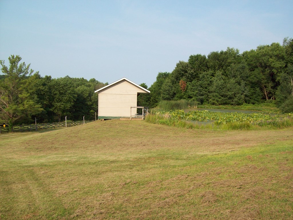 28014 State Rte 27 Guys Mills, PA 16327 - Photo 14 of 22 a view of a large body of water with a building in the background