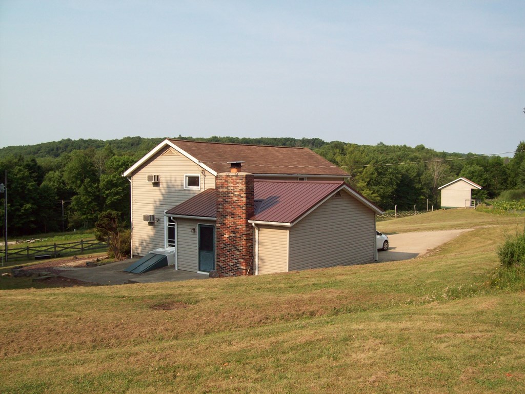28014 State Rte 27 Guys Mills, PA 16327 - Photo 4 of 22 a front view of a house with a yard