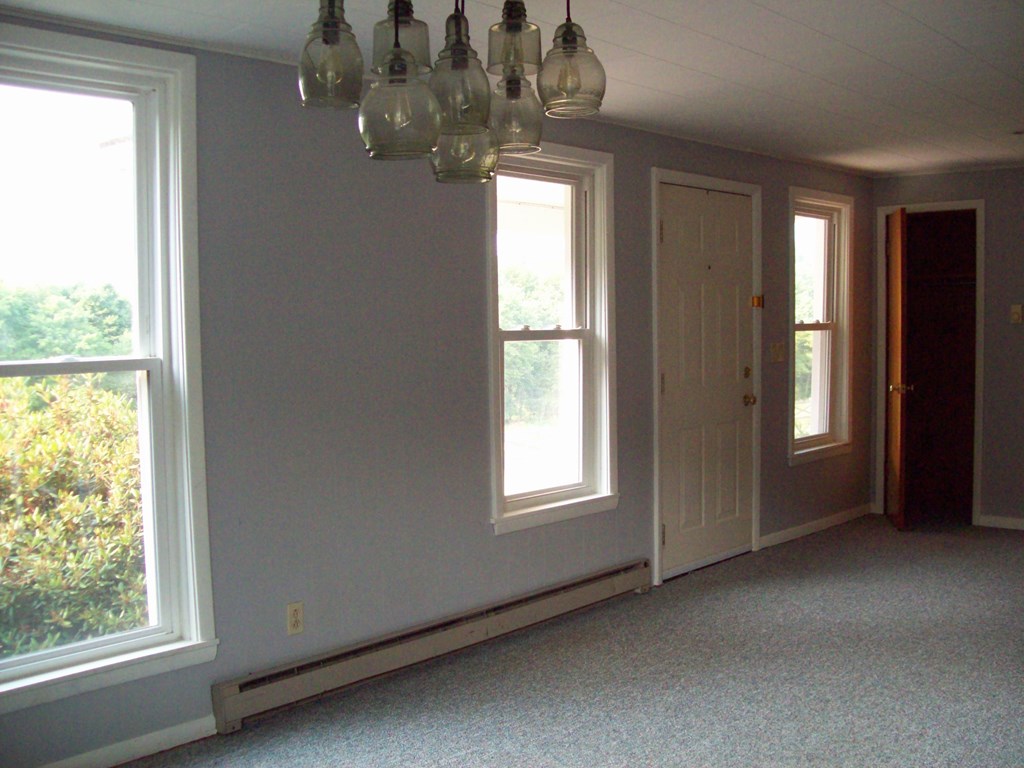 28014 State Rte 27 Guys Mills, PA 16327 - Photo 6 of 22 a view of a livingroom with a chandelier fan and windows