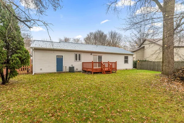 a backyard of a house with table and chairs