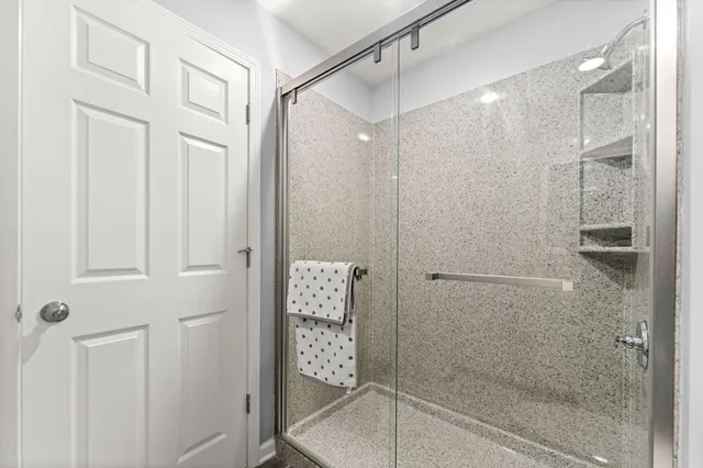 a bathroom with a glass shower door