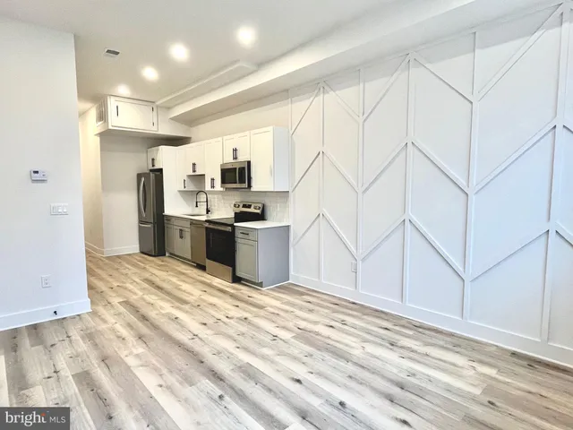 a view of kitchen and wooden floor