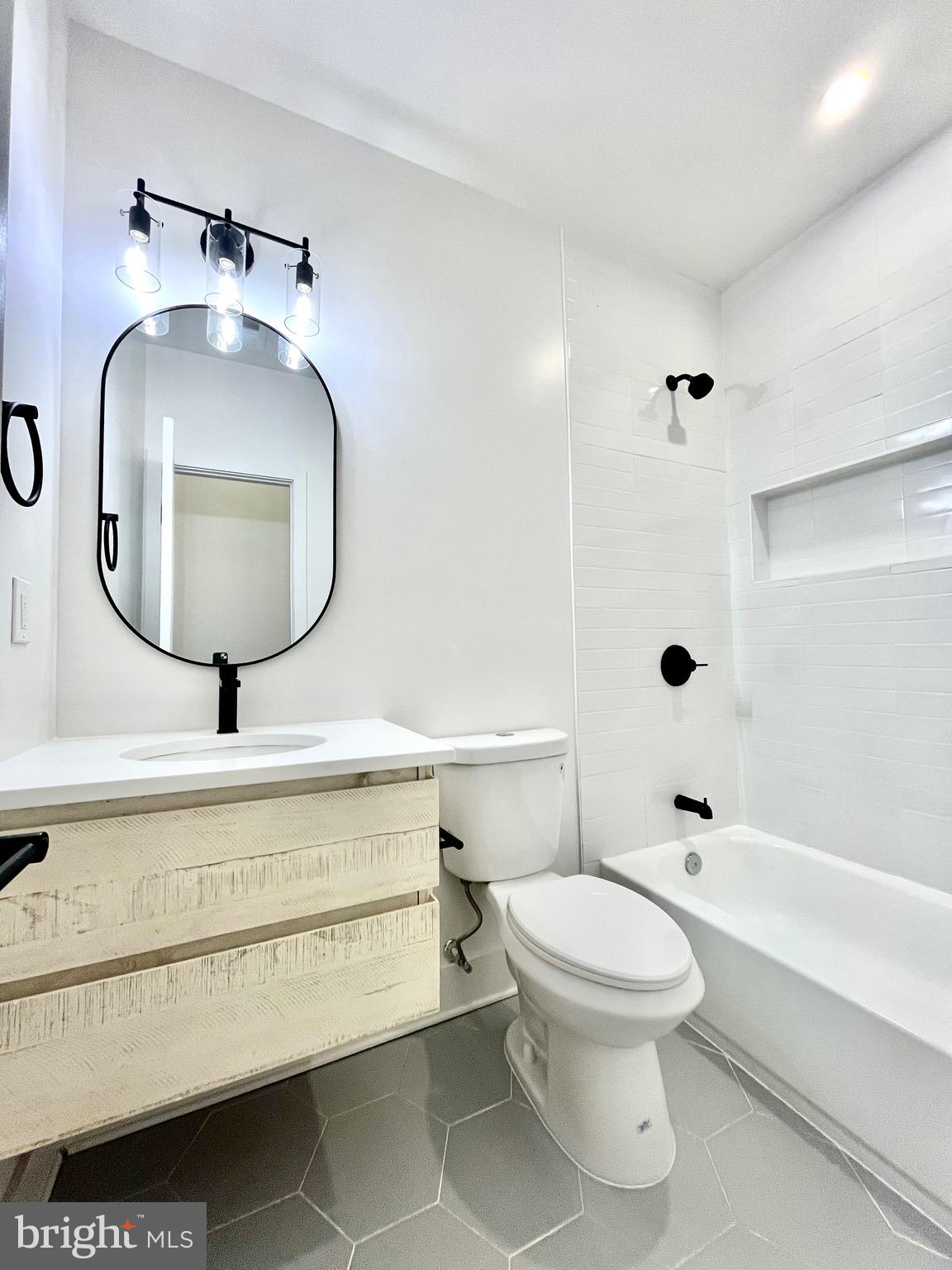 1802 11th Street Northwest, Unit 2A Washington, DC 20001 - Photo 9 of 15 a bathroom with a toilet a sink and mirror