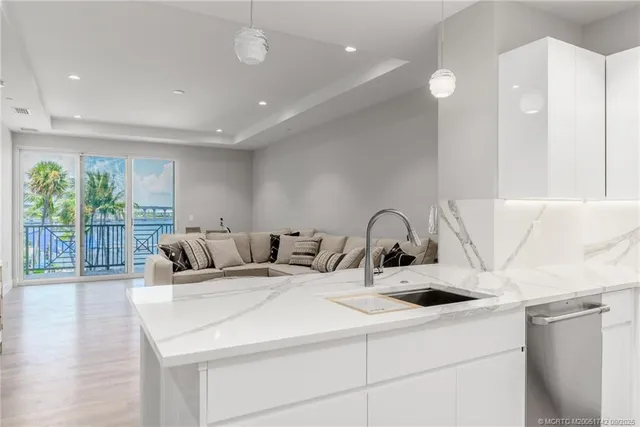 a kitchen with a sink a large window and a rug