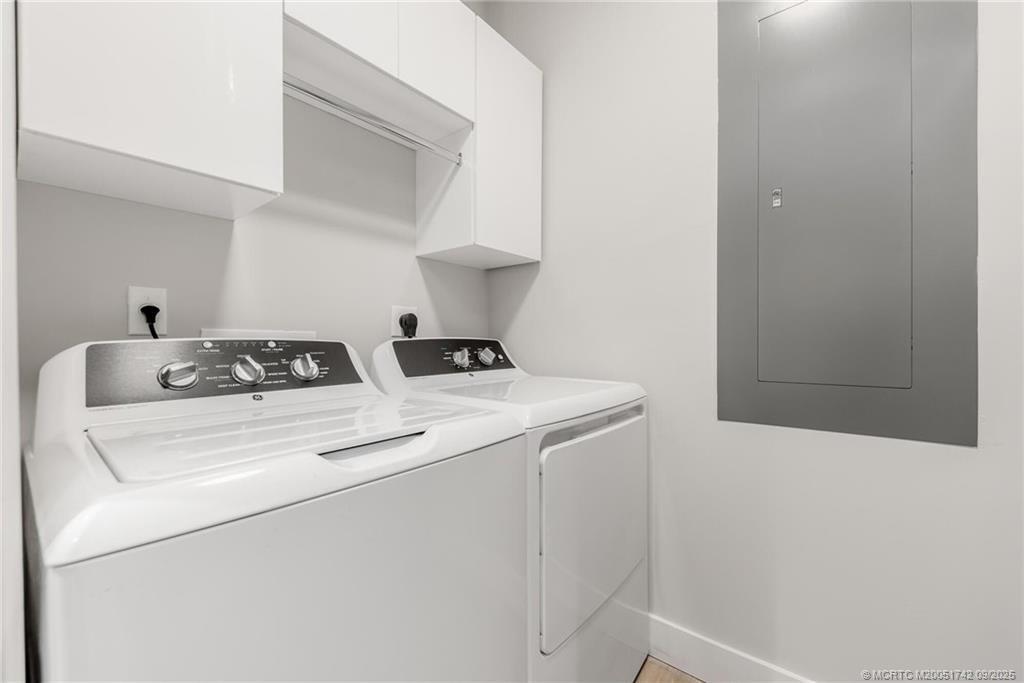 41 Southwest Seminole Street, Unit 305 Stuart, FL 34994 - Photo 21 of 50 a utility room with dryer and washer