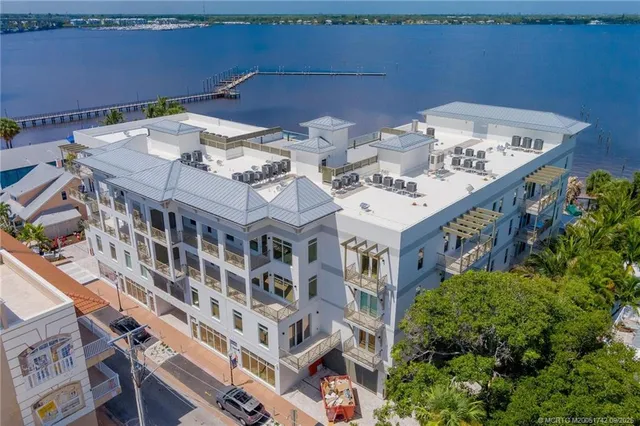 a front view of a building with lake view and boat