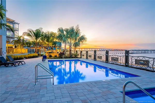 a swimming pool with outdoor seating and yard