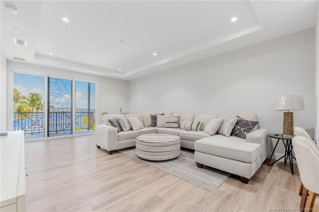 41 Southwest Seminole Street, Unit 305 Stuart, FL 34994 - Photo 7 of 50 a living room with furniture and a large window