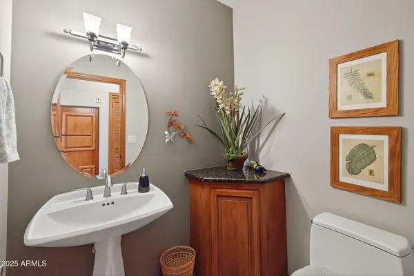 a bathroom with a toilet a sink and a mirror