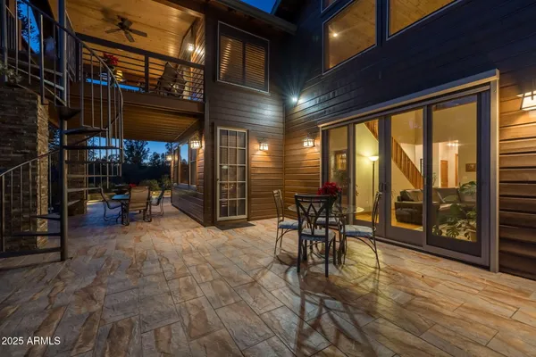 a view of a yard with plants and large trees