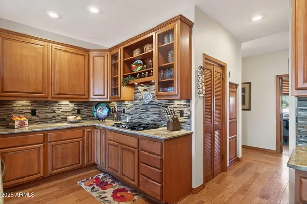 a kitchen with stainless steel appliances granite countertop a refrigerator and a sink