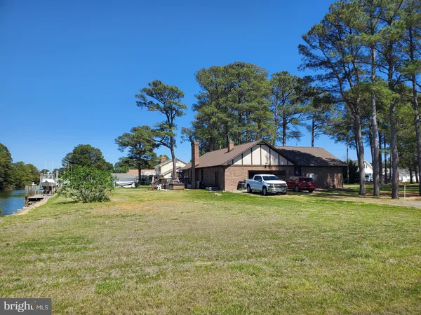 a house with a yard and a large tree