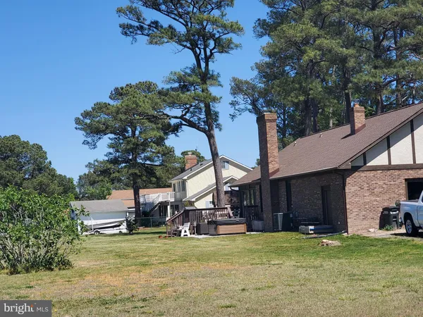 a view of a house with a yard and tree s