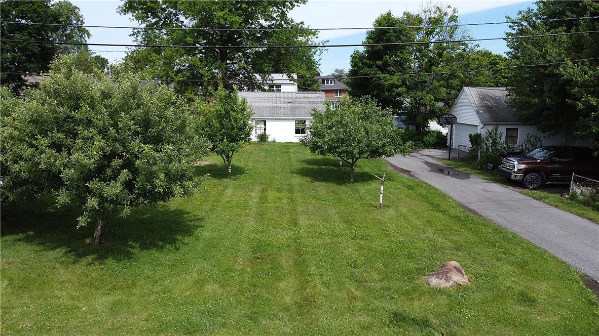 172 Harrison Street Emmaus, PA 18049 - Photo 20 of 30 A verdant, well-maintained lawn stretches toward a home nestled among mature trees, boasting a functional driveway.