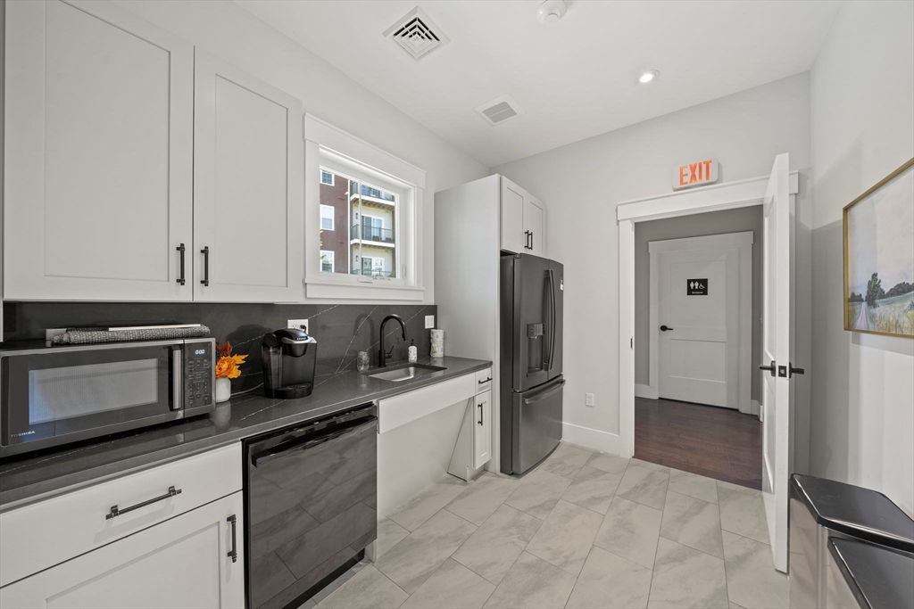 200 Revere Street, Unit 4104 Canton, MA 02021 - Photo 23 of 28 a kitchen with stainless steel appliances a refrigerator a stove a microwave and cabinets