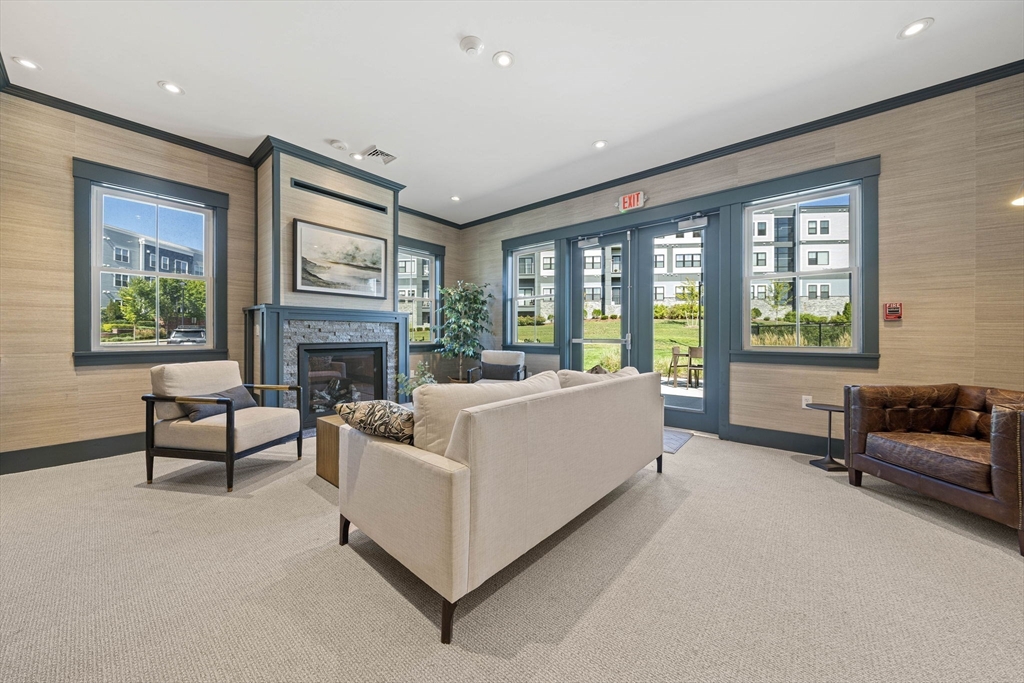 200 Revere Street, Unit 4104 Canton, MA 02021 - Photo 24 of 28 a living room with furniture and a fireplace