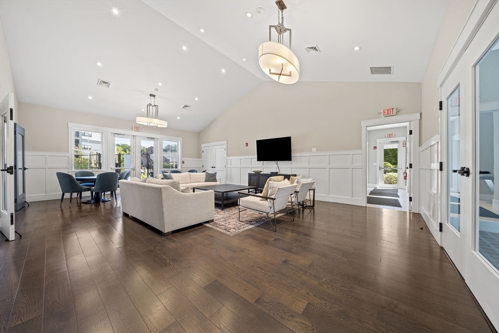 200 Revere Street, Unit 4104 Canton, MA 02021 - Photo 25 of 28 a living room with furniture and a flat screen tv