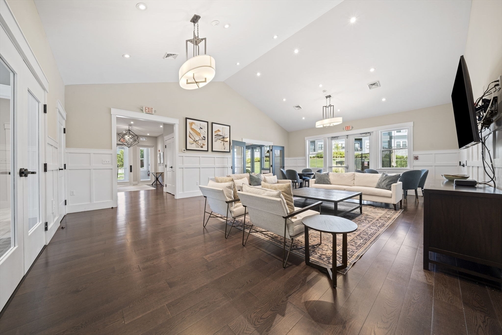 200 Revere Street, Unit 4104 Canton, MA 02021 - Photo 26 of 28 a living room with furniture and a flat screen tv