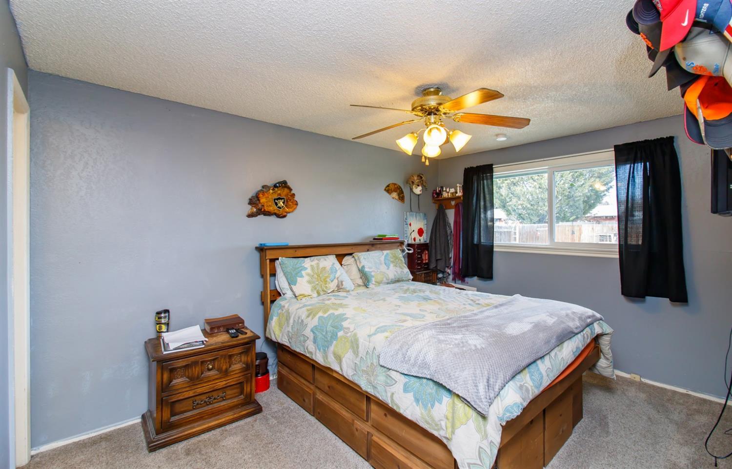 480 Elm Way Eagle Point, OR 97524 - Photo 11 of 26 a bedroom with a bed and a chandelier