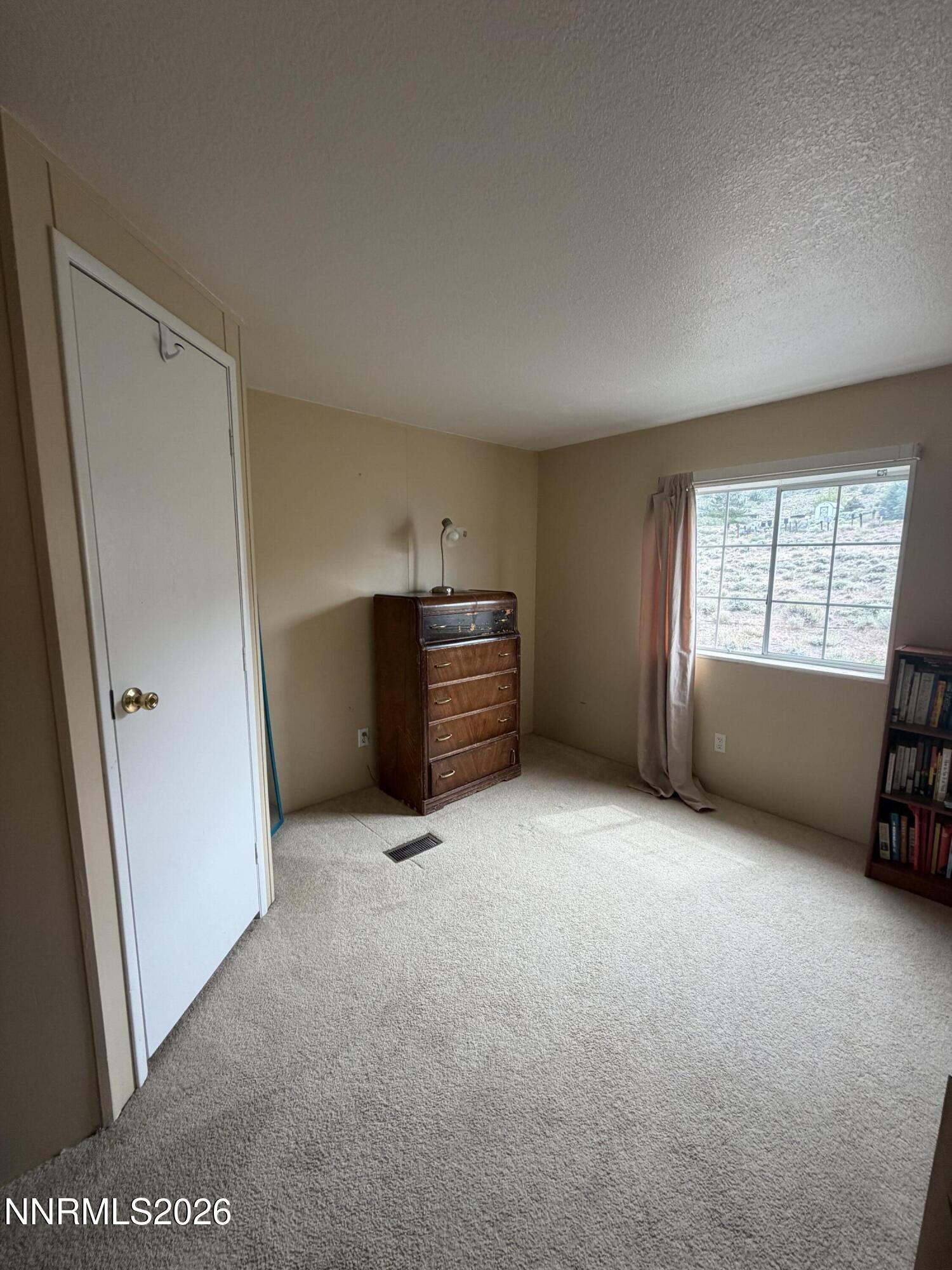 3920 Sandstone Drive Topaz Ranch Estates, NV 89444 - Photo 16 of 20 a view of empty room with furniture and window
