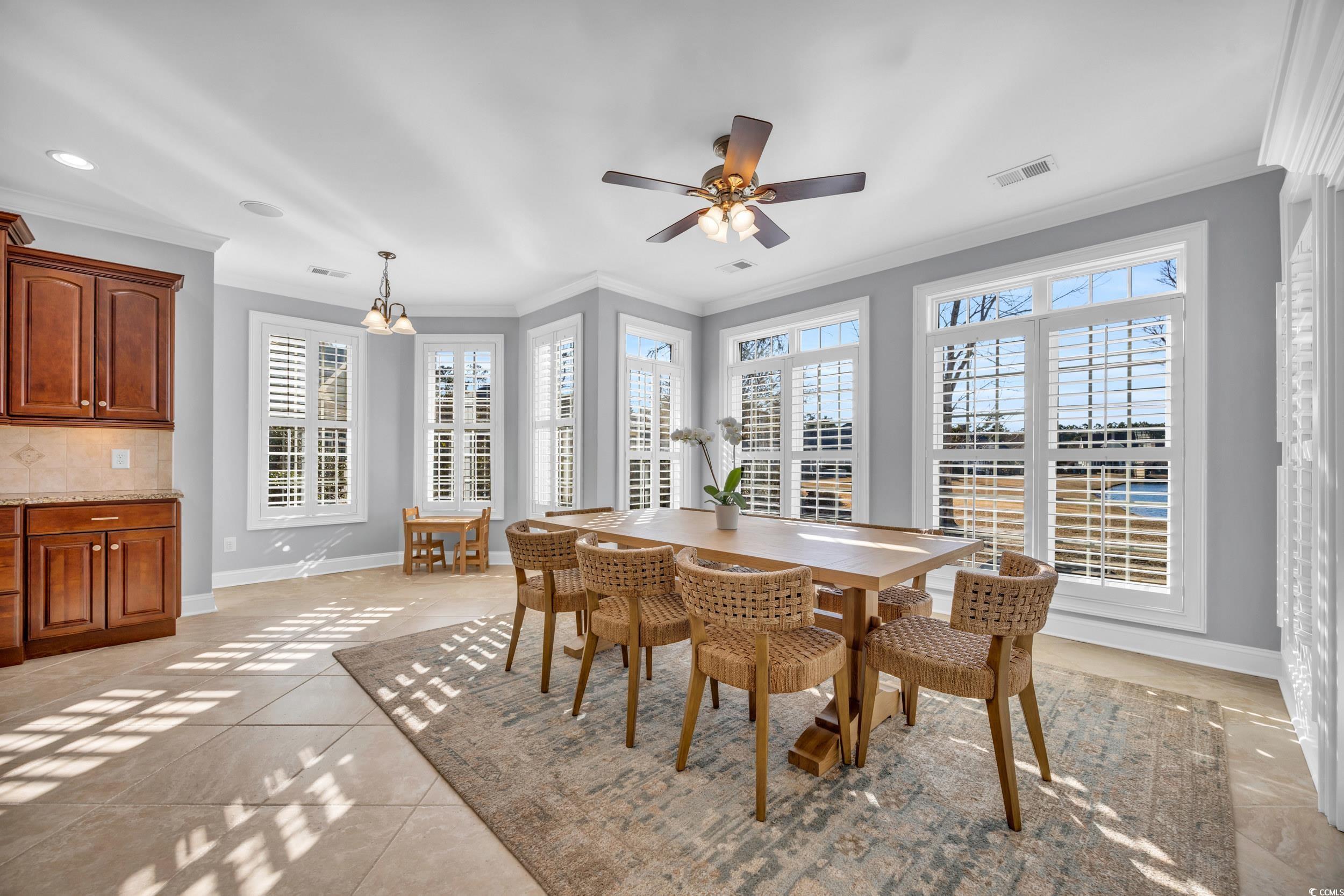 212 Minnow Lane Murrells Inlet, SC 29576 - Photo 11 of 37 Tiled dining space featuring crown molding and cei