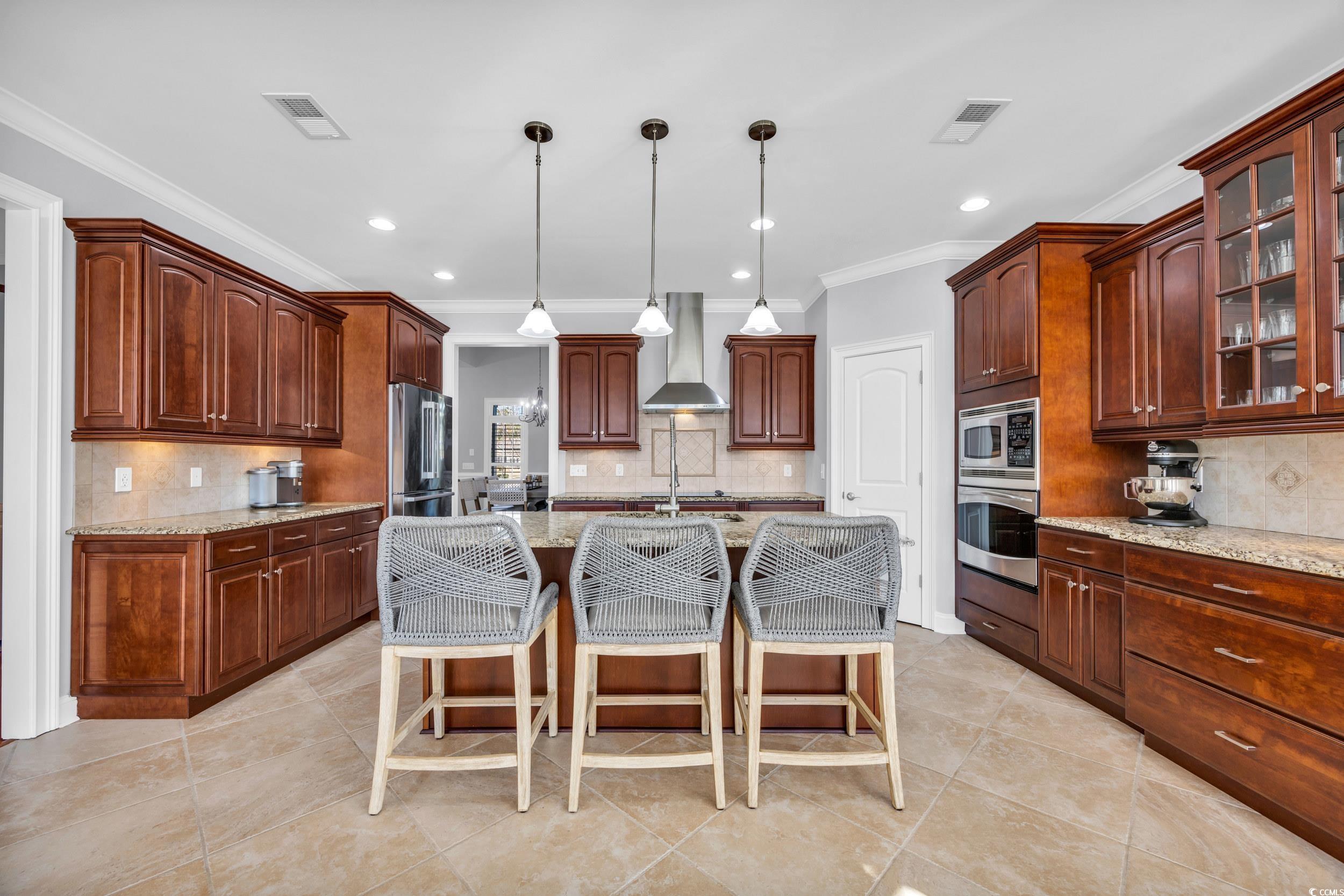 212 Minnow Lane Murrells Inlet, SC 29576 - Photo 8 of 37 Kitchen with hanging light fixtures, a center isla