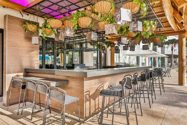 a view of a patio with table and chairs and potted plants