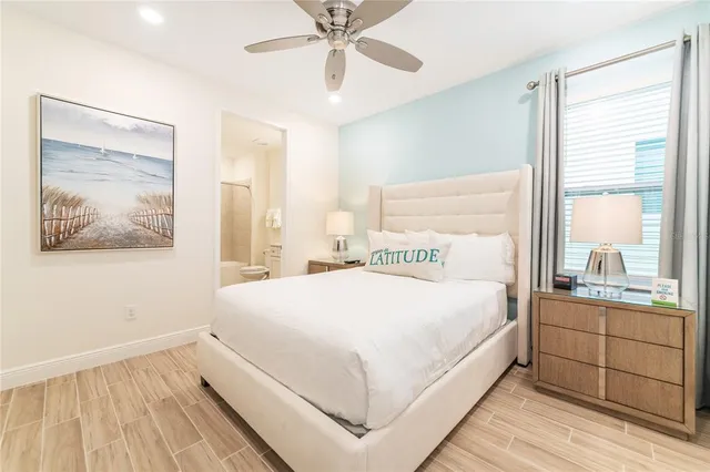 a large bed sitting in a bedroom next to a window