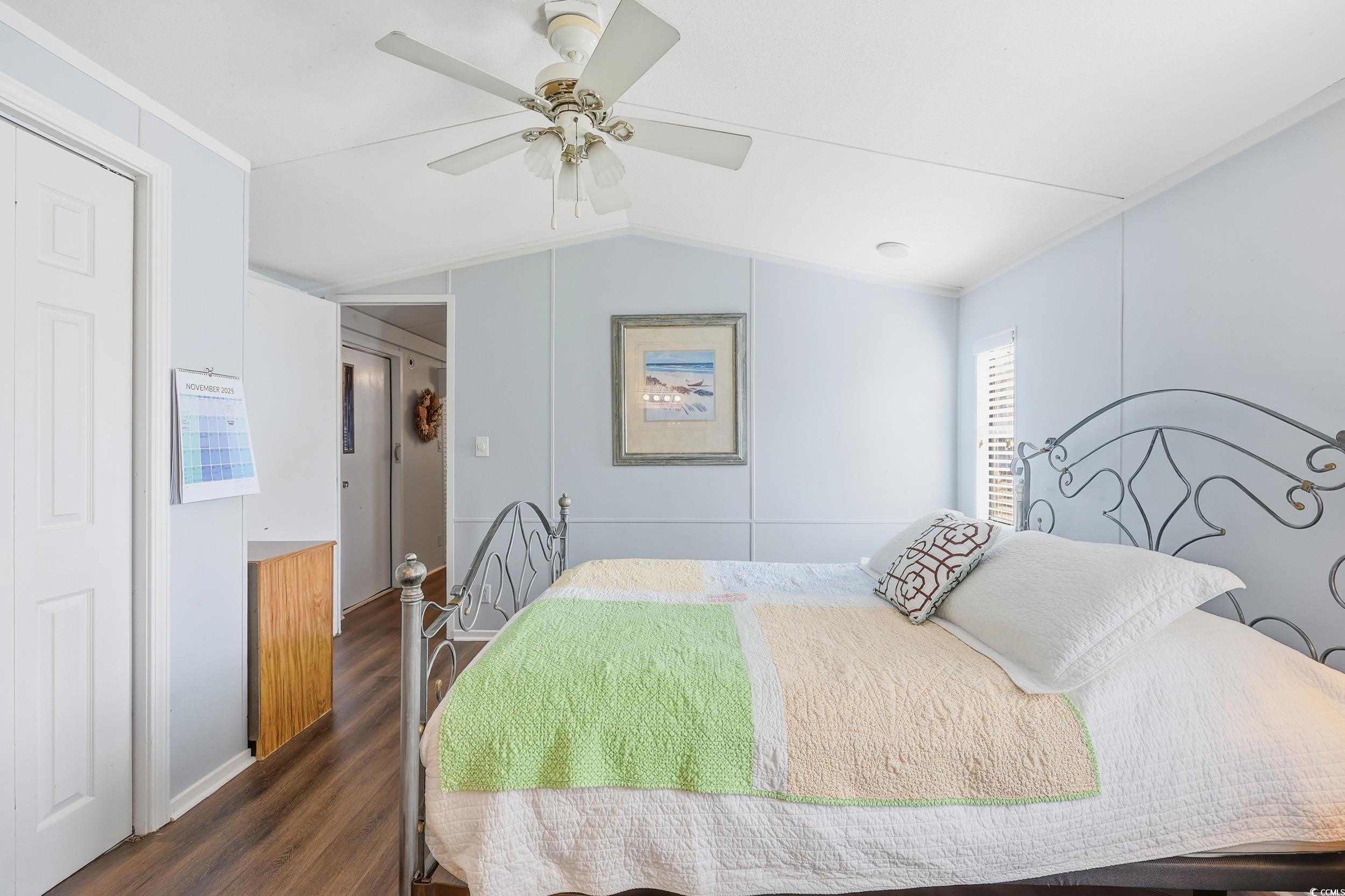 1017 Foxfire Drive North Myrtle Beach, SC 29582 - Photo 16 of 36 Bedroom featuring ceiling fan, dark wood-type flooring, ornamental molding, and vaulted ceiling