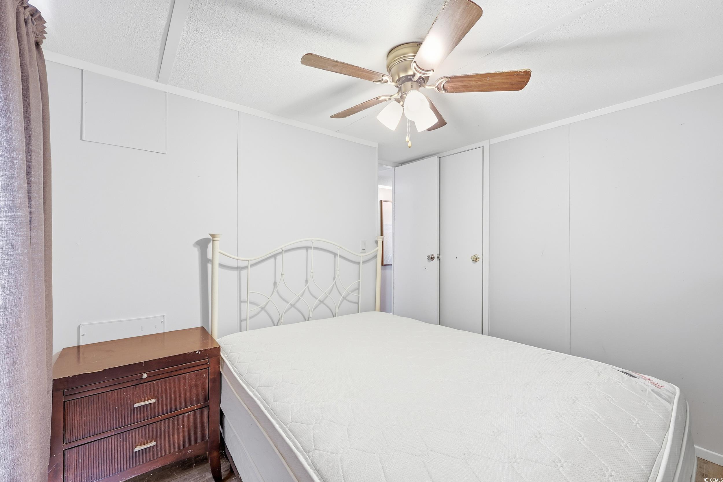 1017 Foxfire Drive North Myrtle Beach, SC 29582 - Photo 23 of 36 Bedroom featuring ceiling fan, crown molding, and a decorative wall