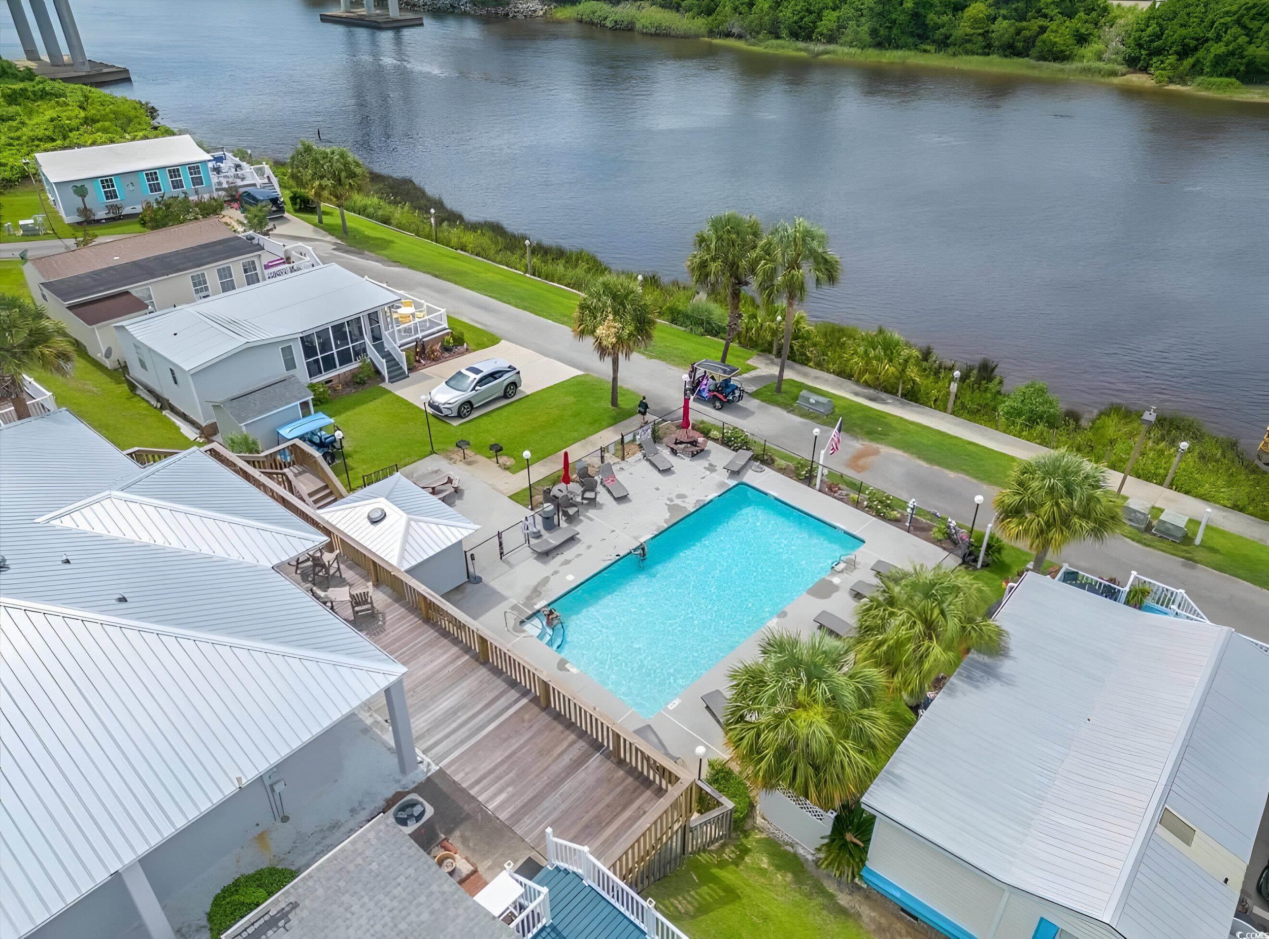 1017 Foxfire Drive North Myrtle Beach, SC 29582 - Photo 3 of 36 Aerial view of a nearby body of water and a pool area