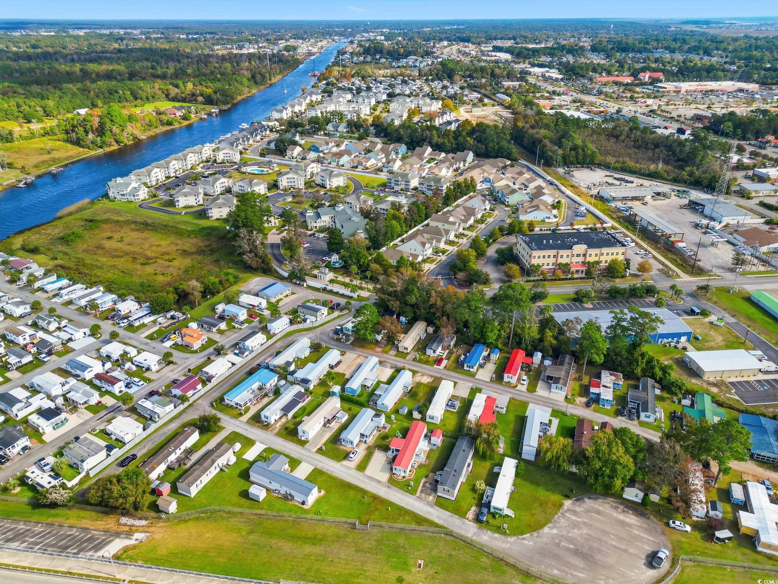 1017 Foxfire Drive North Myrtle Beach, SC 29582 - Photo 31 of 36 Aerial overview of property's location featuring a large body of water and nearby suburban area
