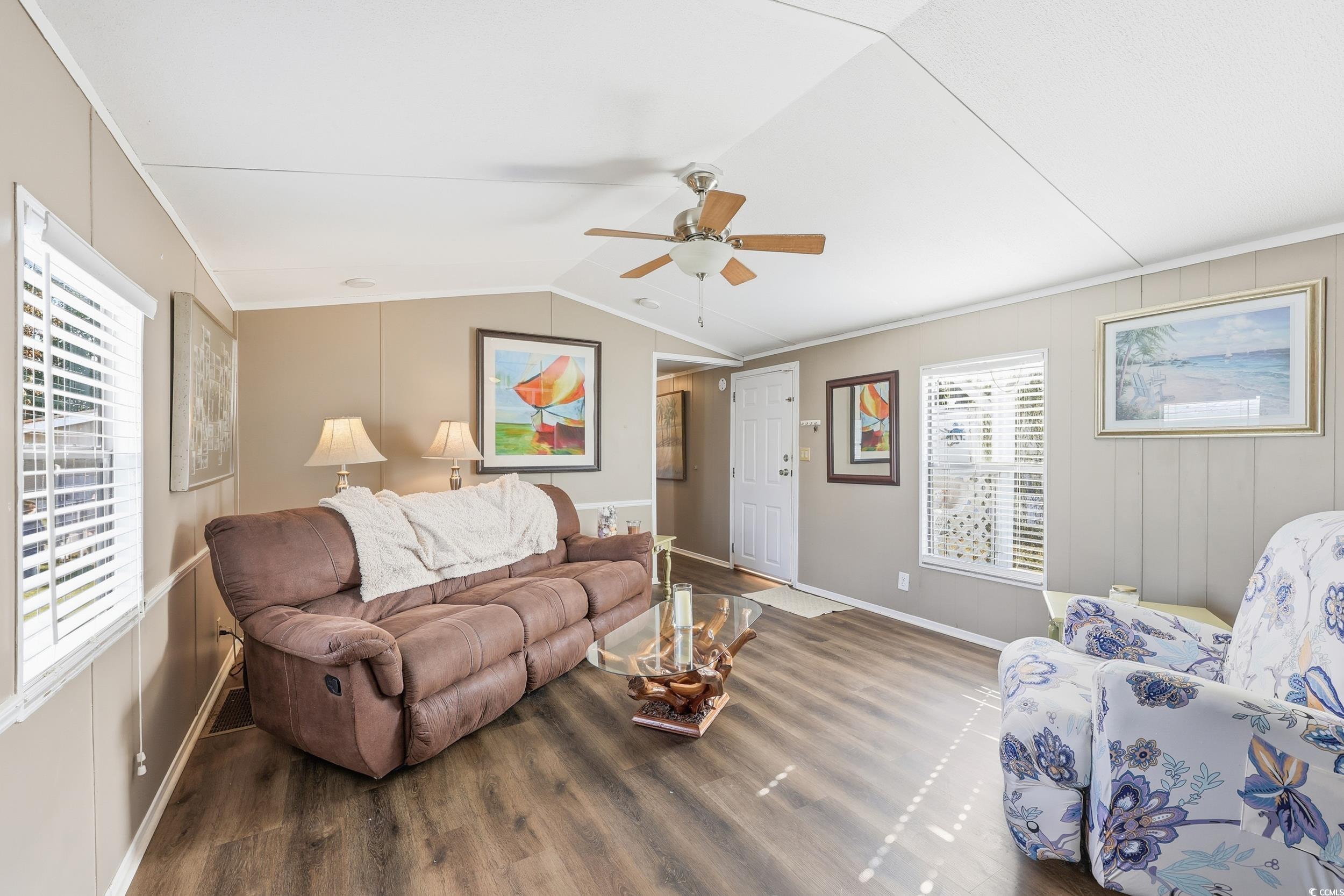 1017 Foxfire Drive North Myrtle Beach, SC 29582 - Photo 4 of 36 Living room featuring wood finished floors, a ceiling fan, lofted ceiling, and crown molding