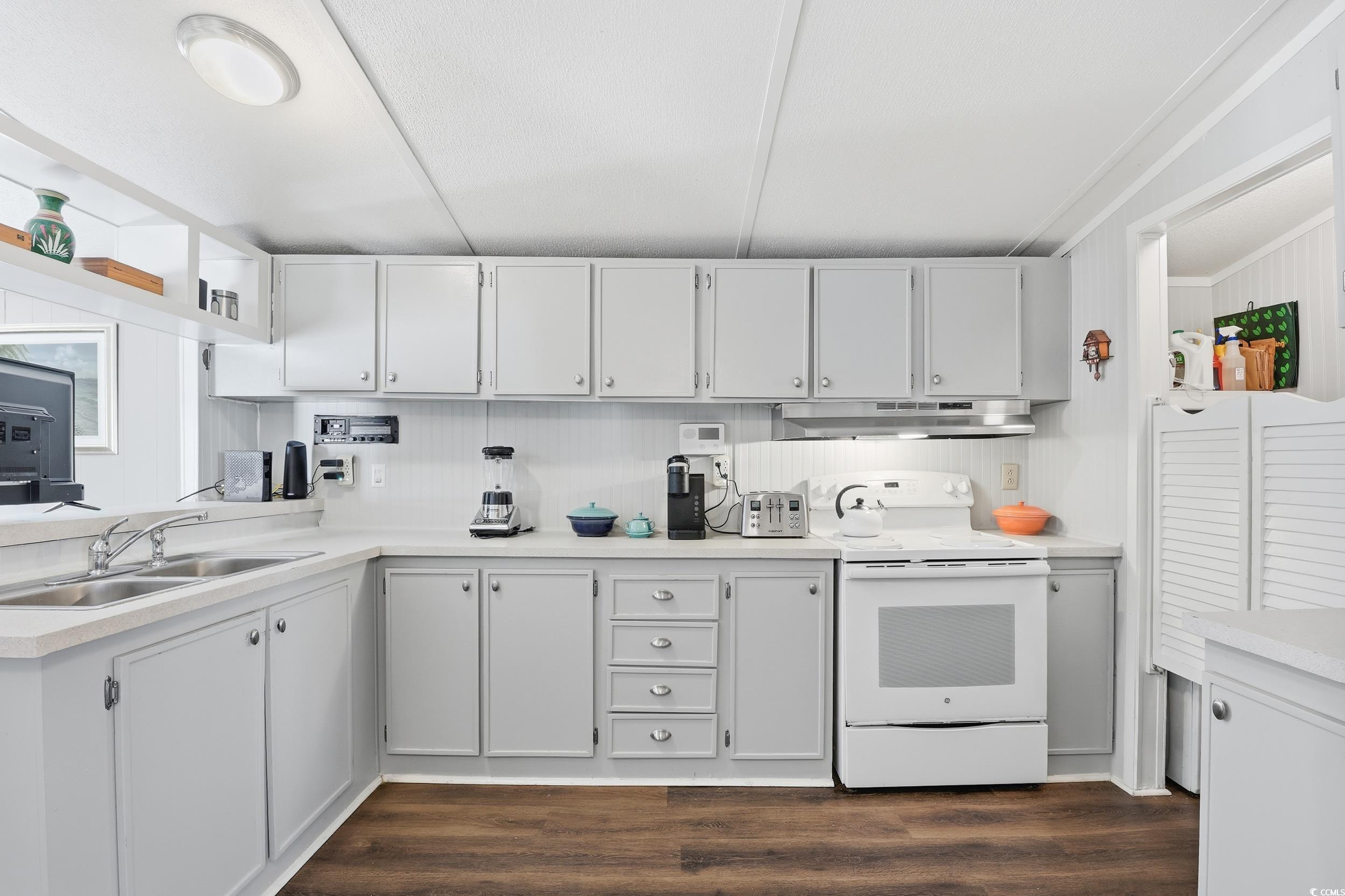 1017 Foxfire Drive North Myrtle Beach, SC 29582 - Photo 6 of 36 Kitchen featuring light countertops, white cabinetry, electric stove, and dark wood finished floors