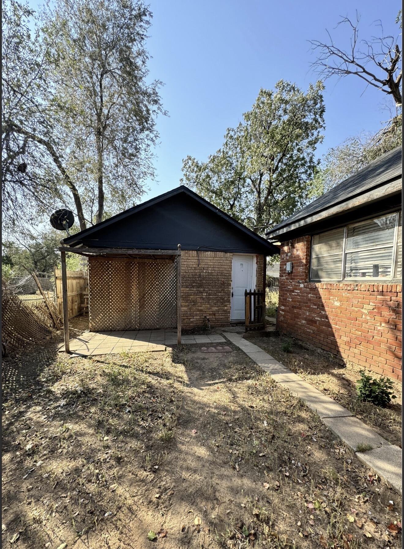 2109 22nd Street, Unit REAR Lubbock, TX 79411 - Photo 1 of 11 a house with trees in the background