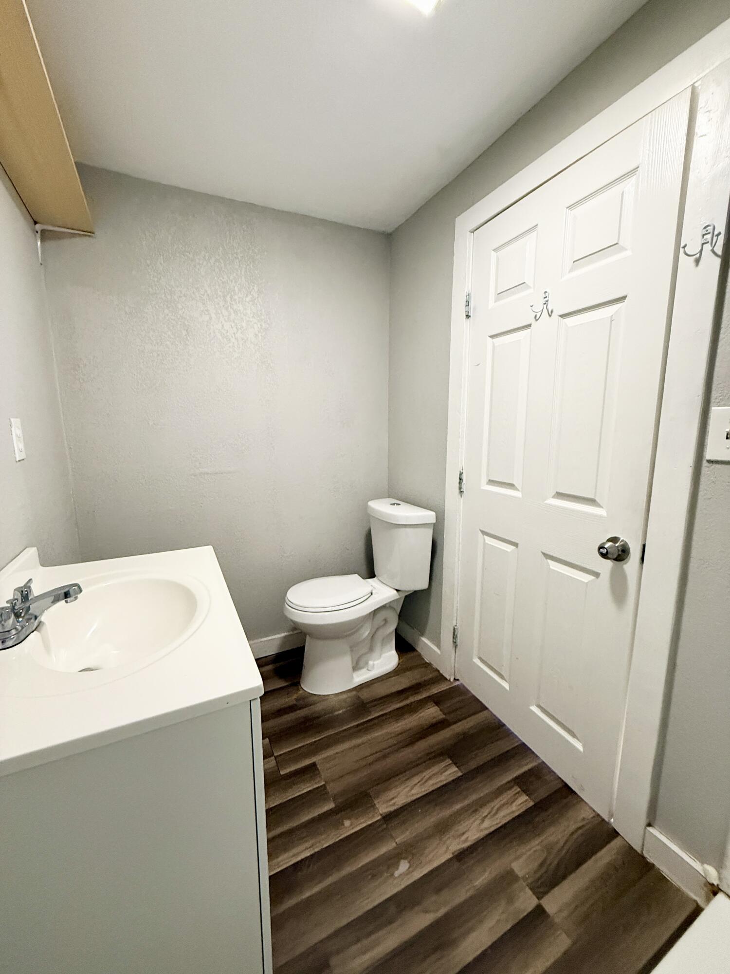 2109 22nd Street, Unit REAR Lubbock, TX 79411 - Photo 11 of 11 a bathroom with a sink toilet and vanity