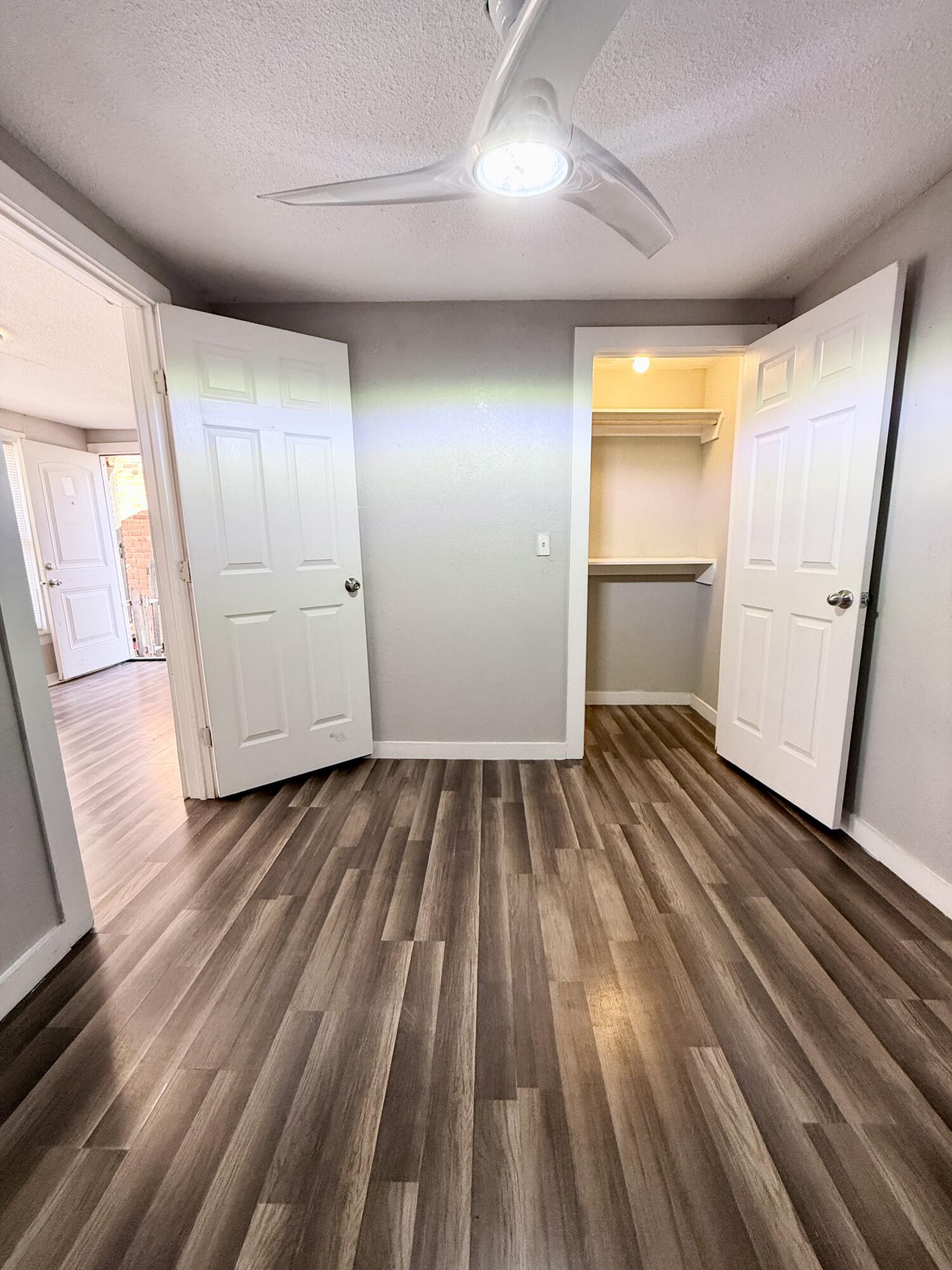 2109 22nd Street, Unit REAR Lubbock, TX 79411 - Photo 9 of 11 a view of a room with wooden floor and electronic appliances
