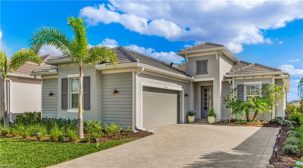 43080 Boardwalk Loop Babcock Ranch, FL 33982 - Photo 21 of 21 a front view of a house with a garden