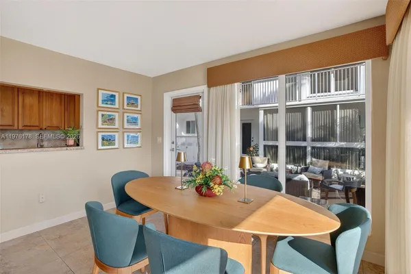 a kitchen with stainless steel appliances granite countertop a sink a stove and a refrigerator with wooden cabinets