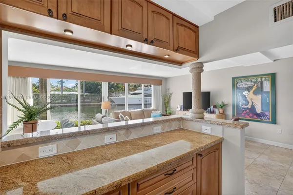 a view of a hallway with wooden floor windows and a livingroom